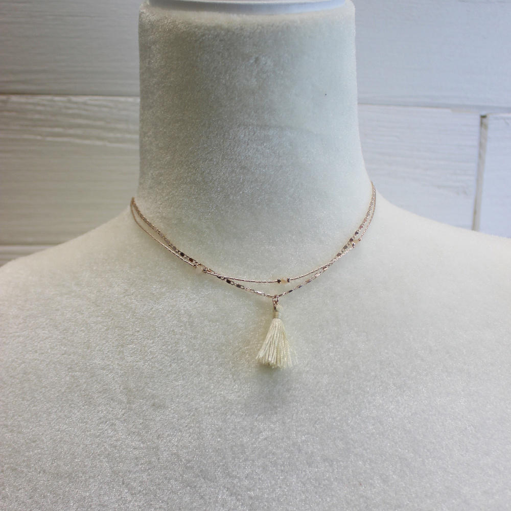 Gold necklace with white tassel
